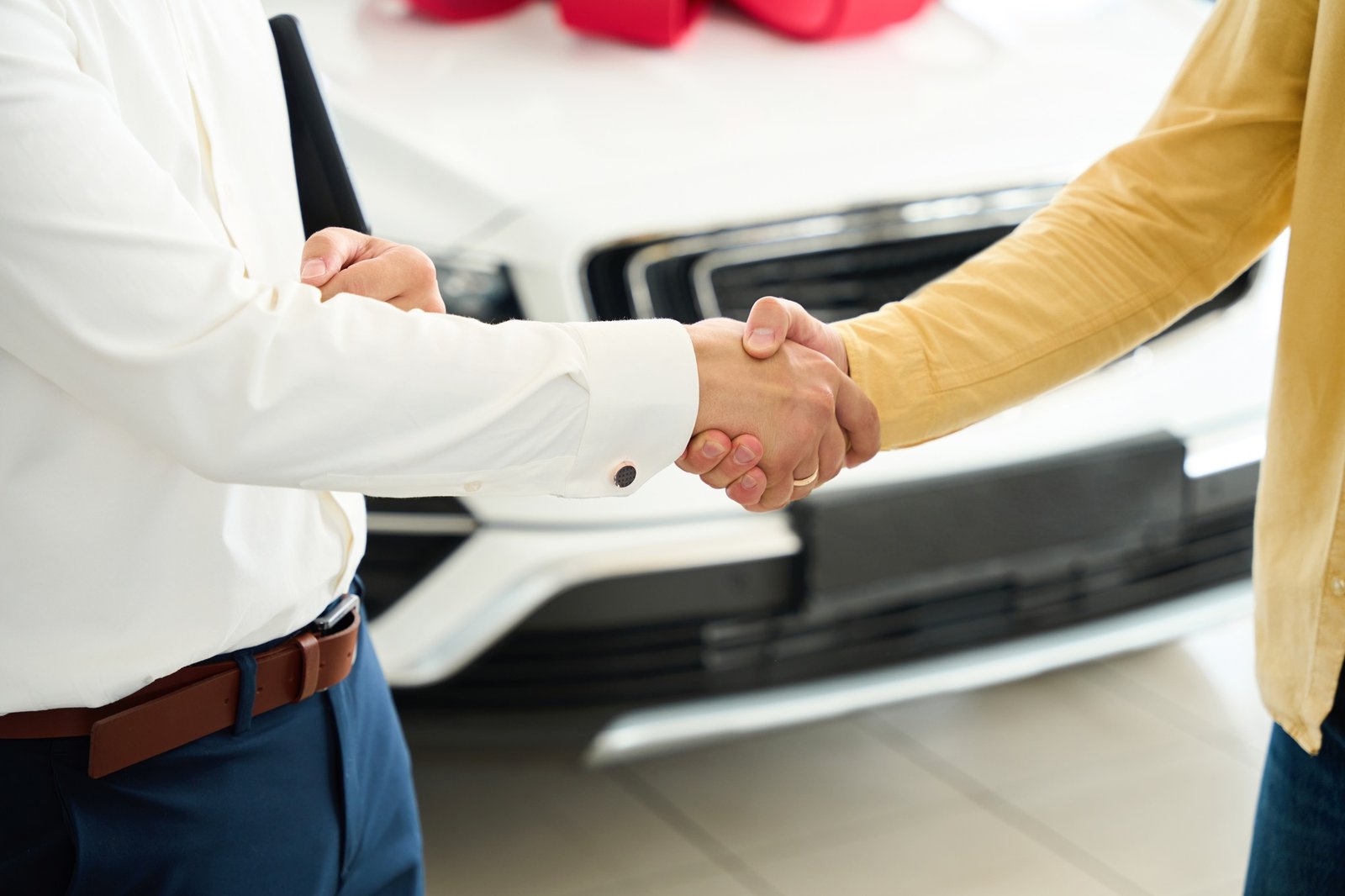 Manager congratulates a man on buying a car